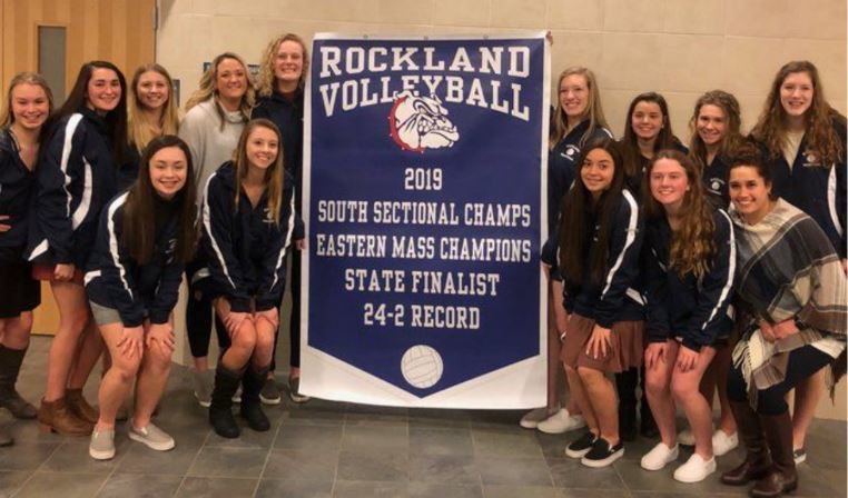 Volleyball Team with their banner